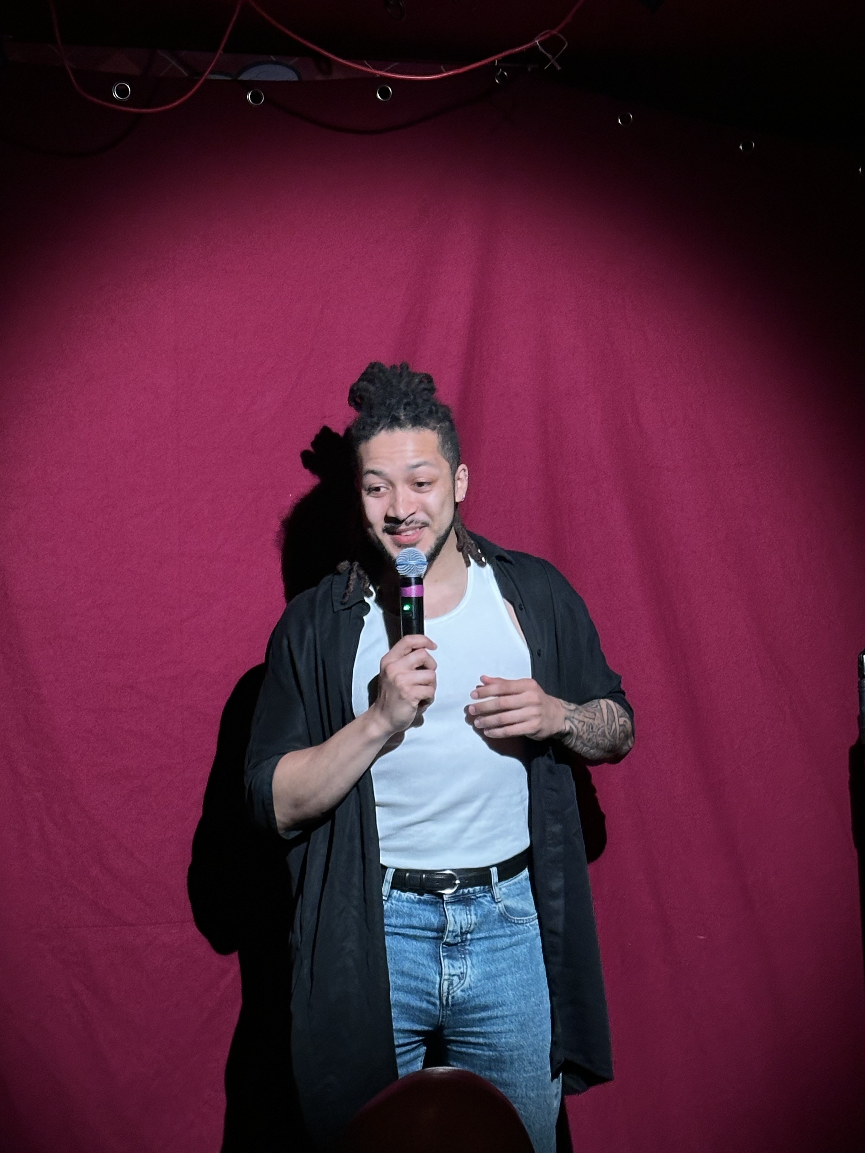 Comedian on stage at No Stress